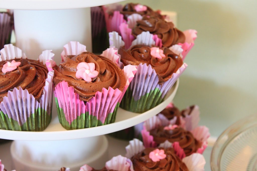 Floral cupcake liners and a royal icing flower add a Springtime touch to these chocolate frosted cupcakes.