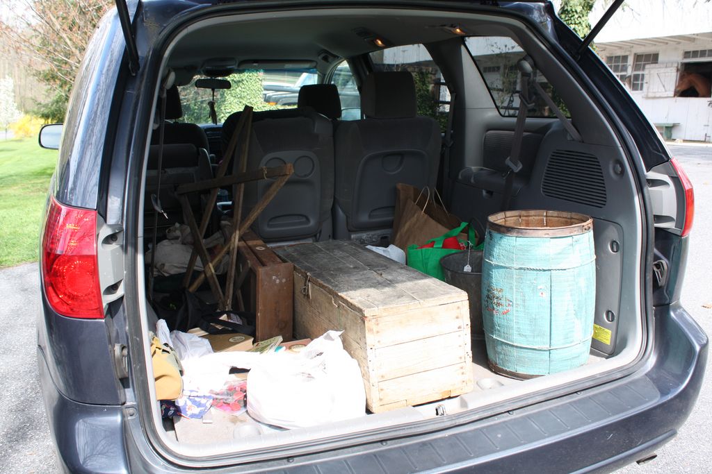 open trunk of an SUV full of antique items from an antiquing trip in Adamstown PA.